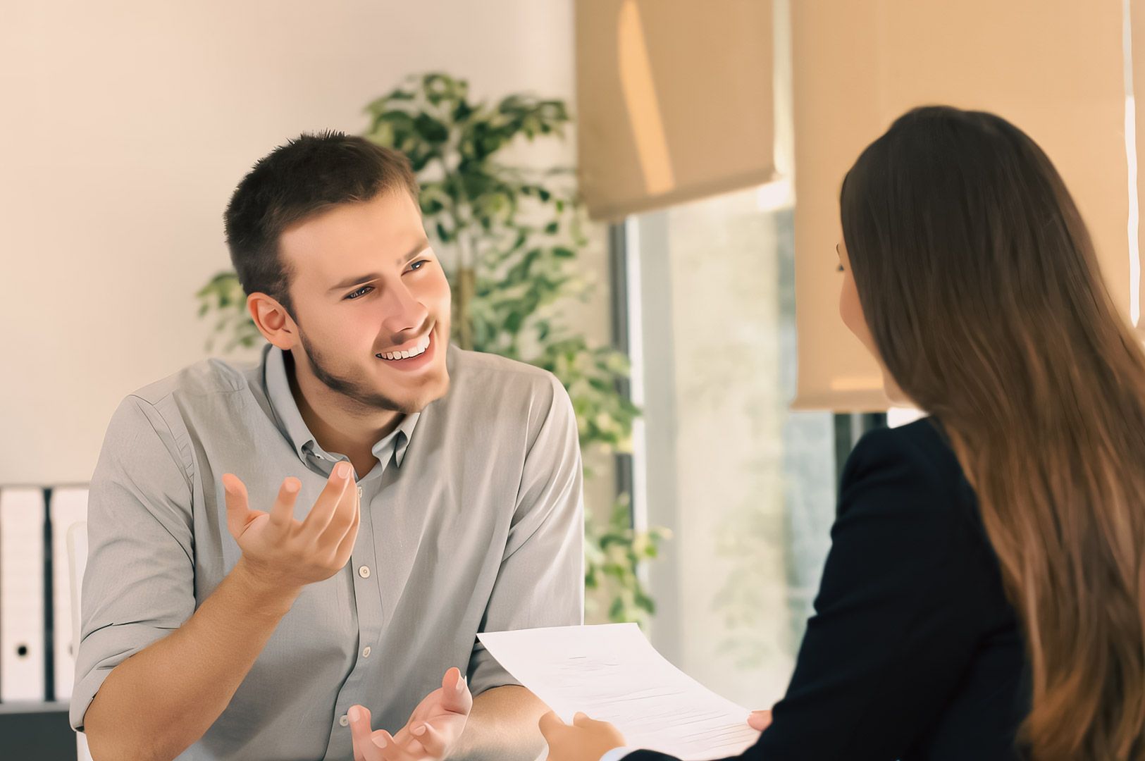 Business meeting with two professionals discussing documents in a modern office setting.