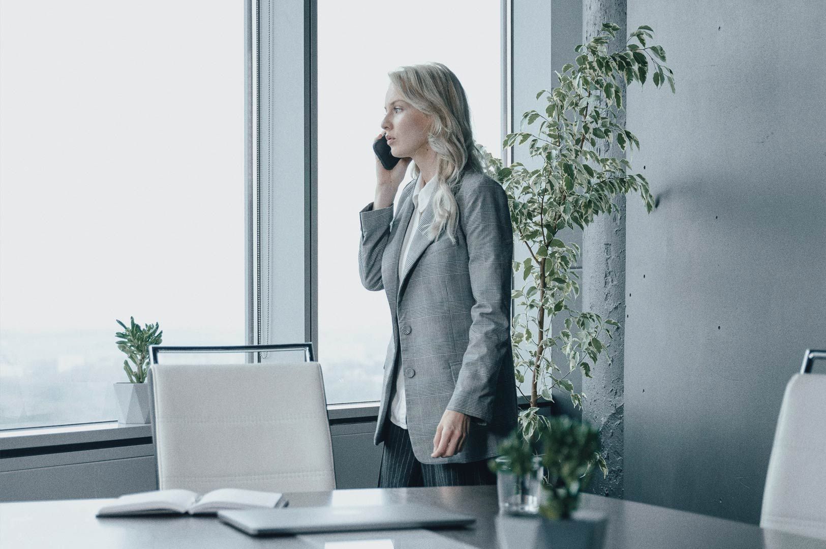 Business professional on phone in modern office.