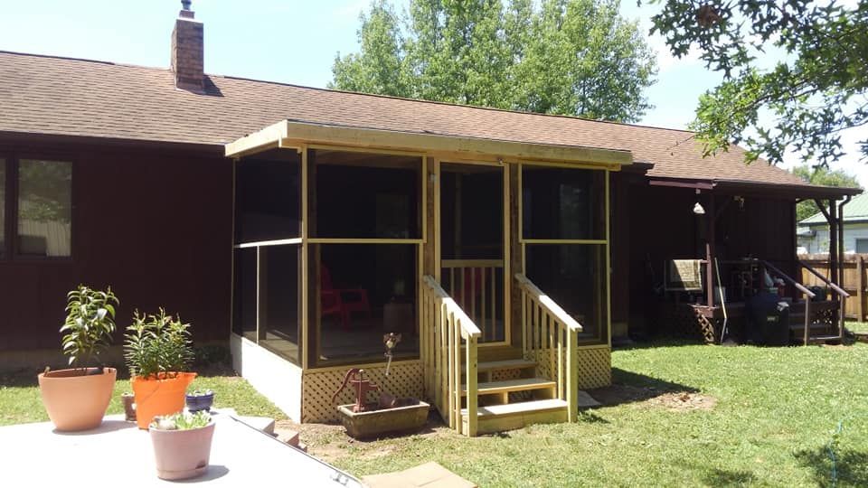 A screened in porch in front of a house