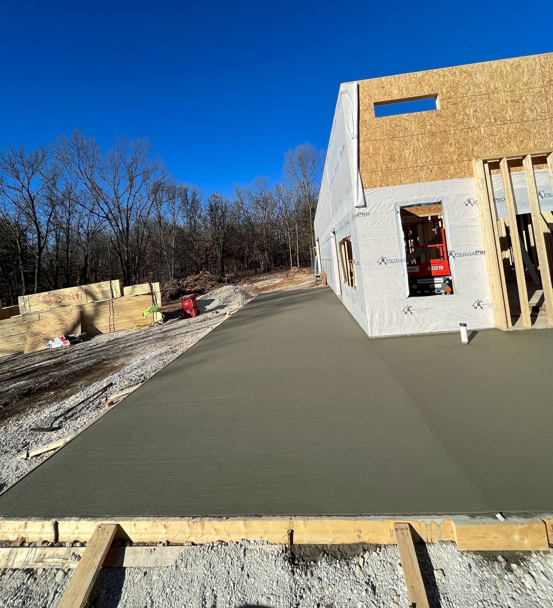 A house is being built on a concrete foundation.