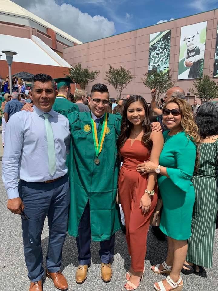 A group of people are posing for a picture at a graduation ceremony.