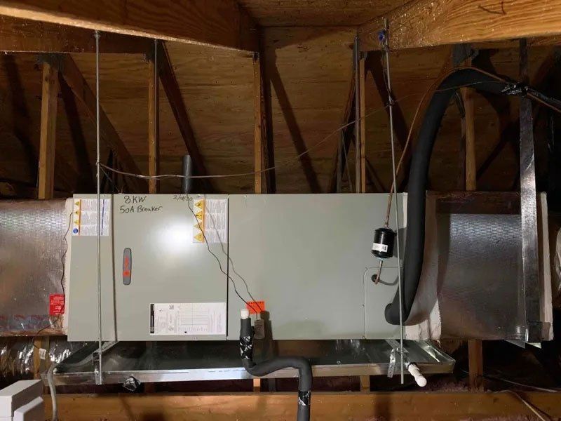 An air conditioner is installed in the attic of a house.