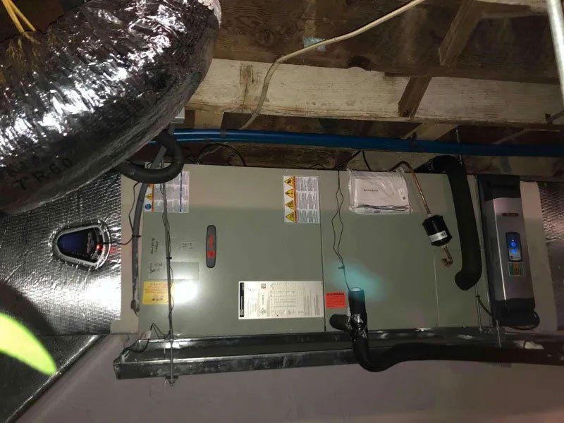 An air conditioner is hanging from the ceiling of a room.