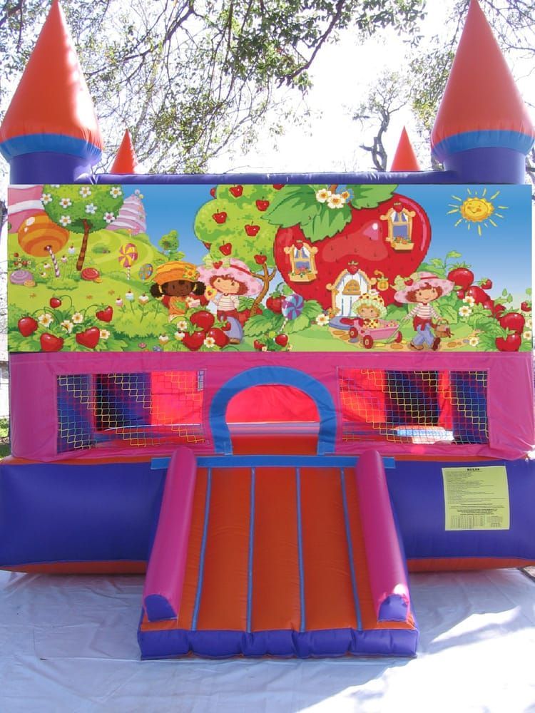 A bouncy house with a picture of strawberry shortcake on it