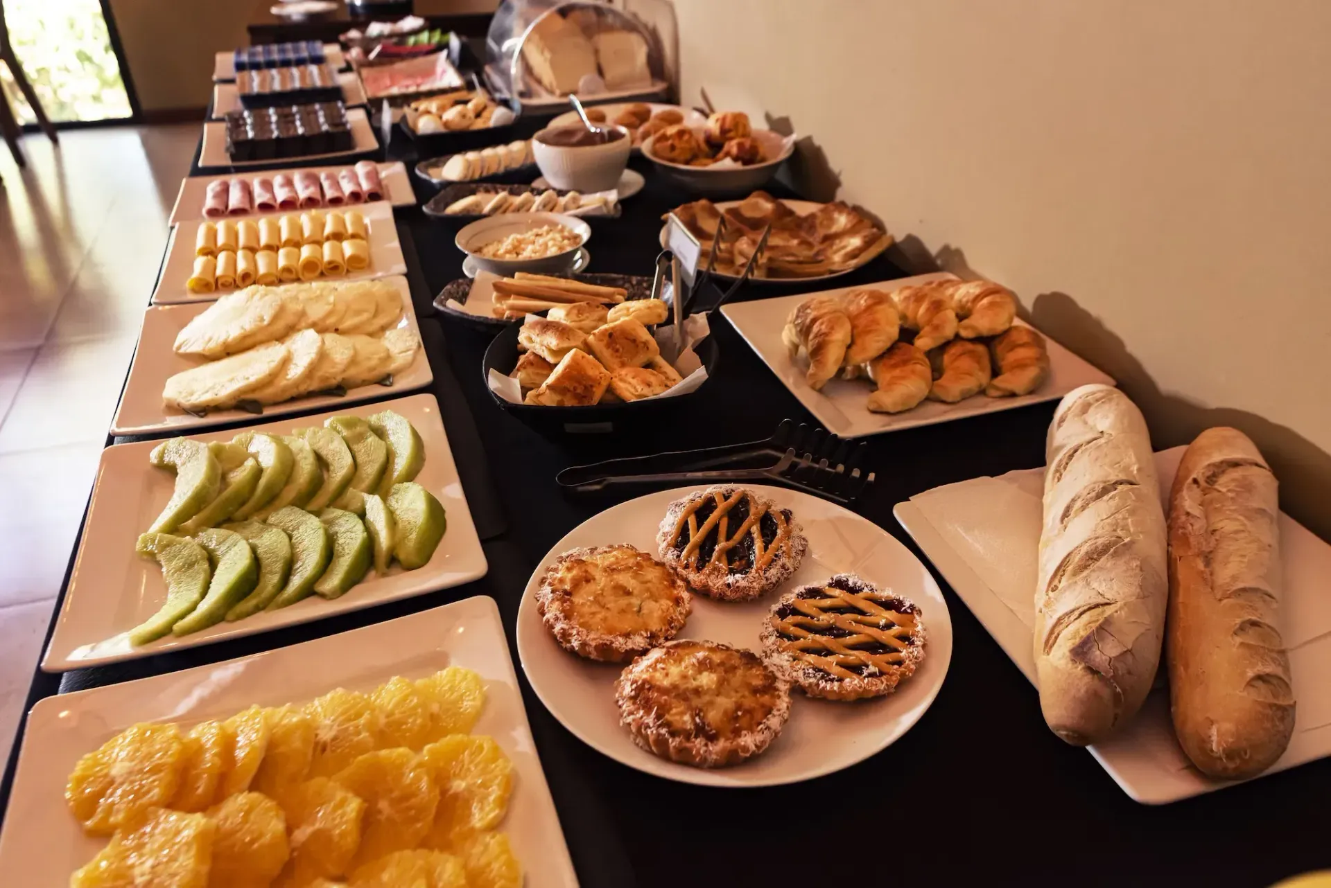 A buffet table with a variety of food on it
