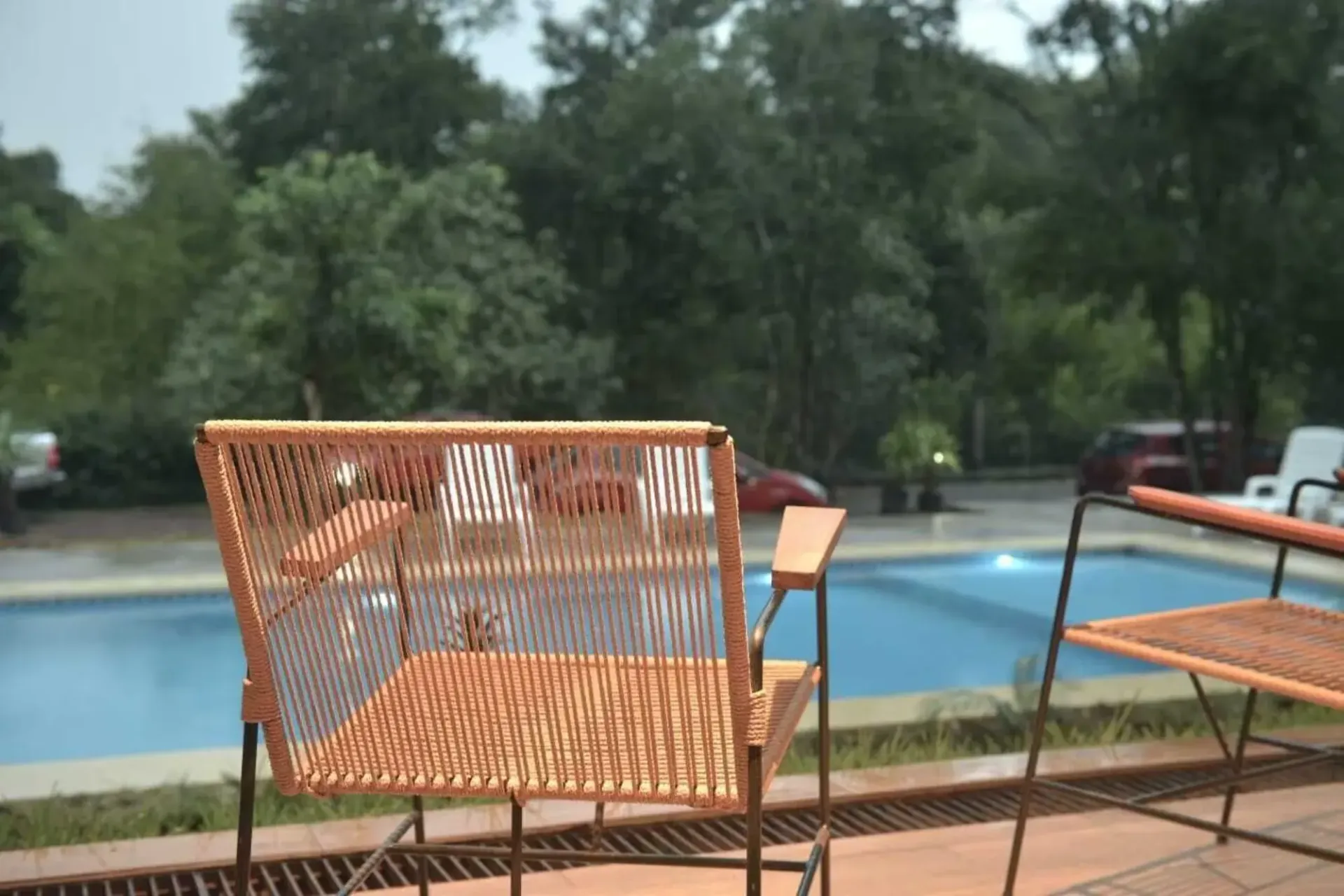 A chair is sitting in front of a swimming pool