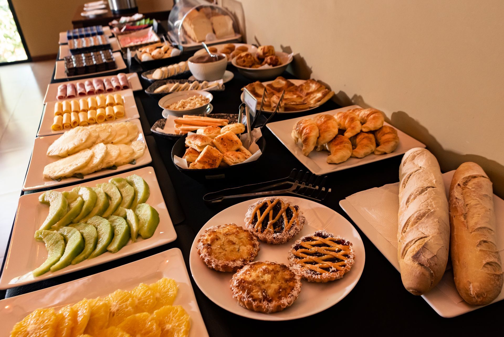 A buffet table with a variety of food on it