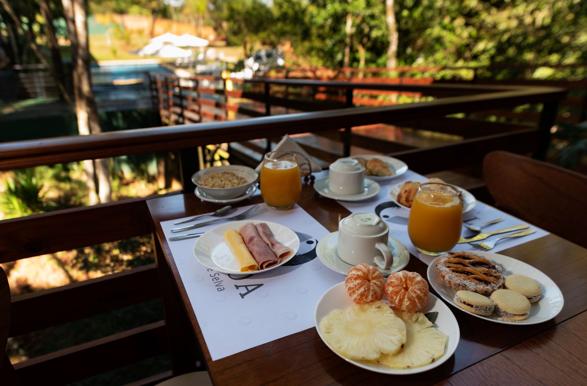 A table topped with plates of food and drinks.
