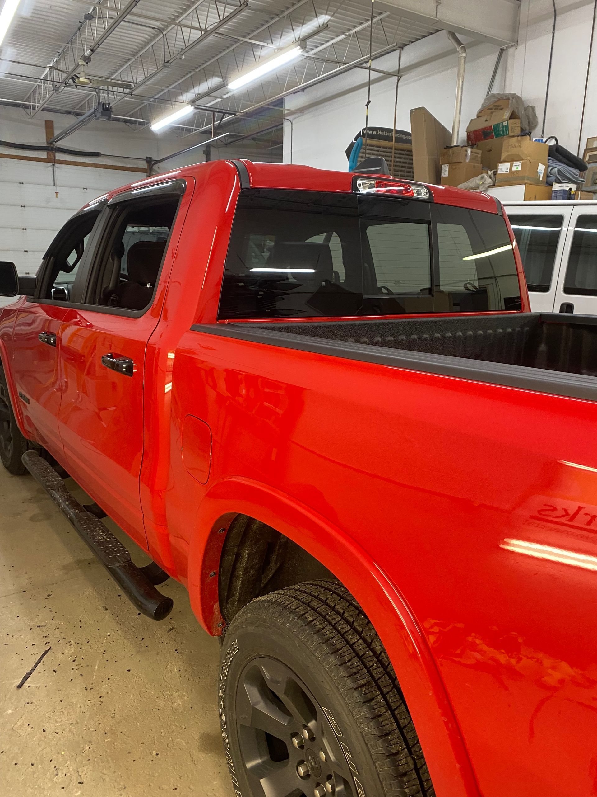 Red pickup truck in a garage.