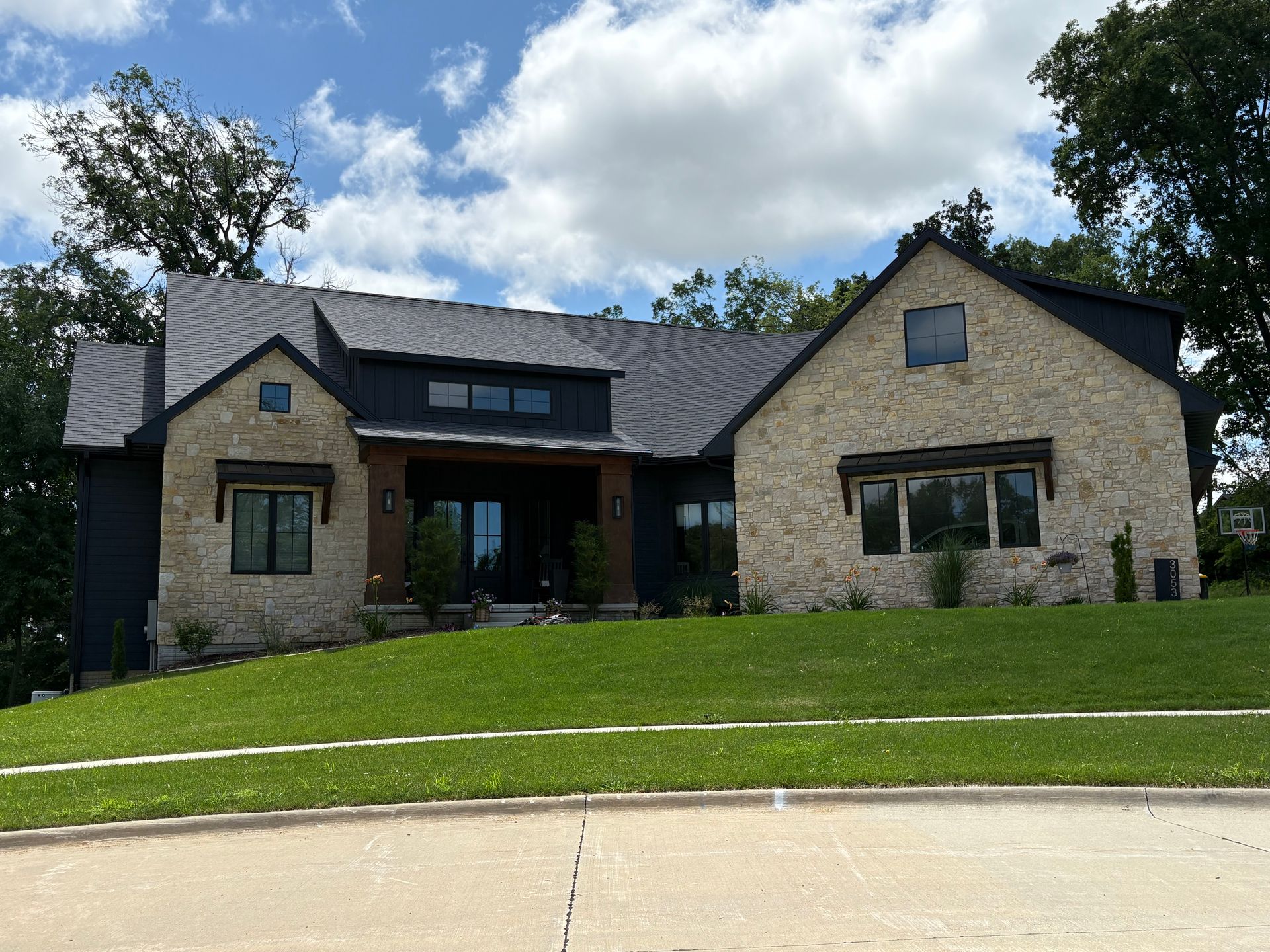 A small white dog is standing in a room under construction.
