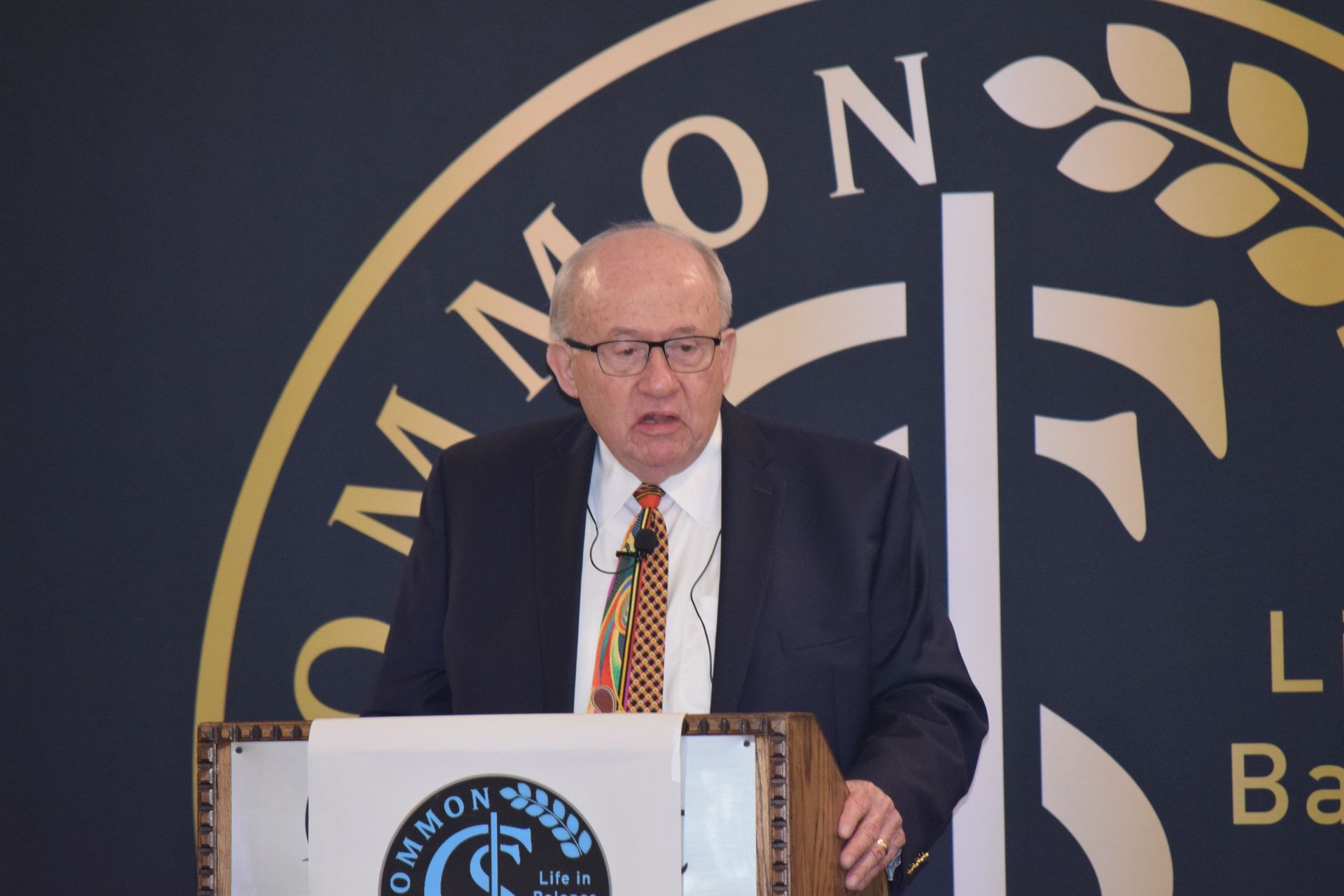 A man in a suit and tie is giving a speech