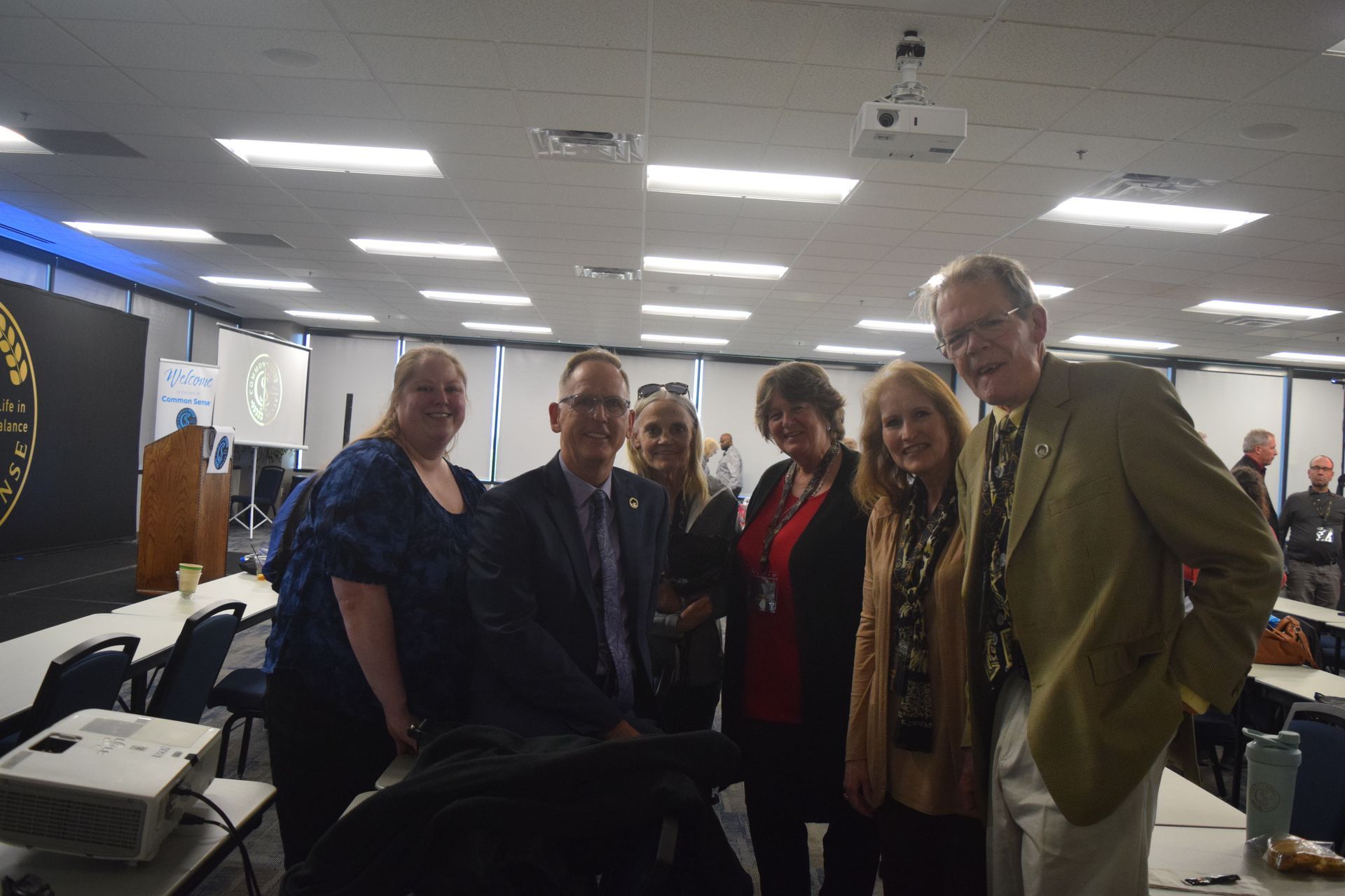 A group of people are posing for a picture in a room.