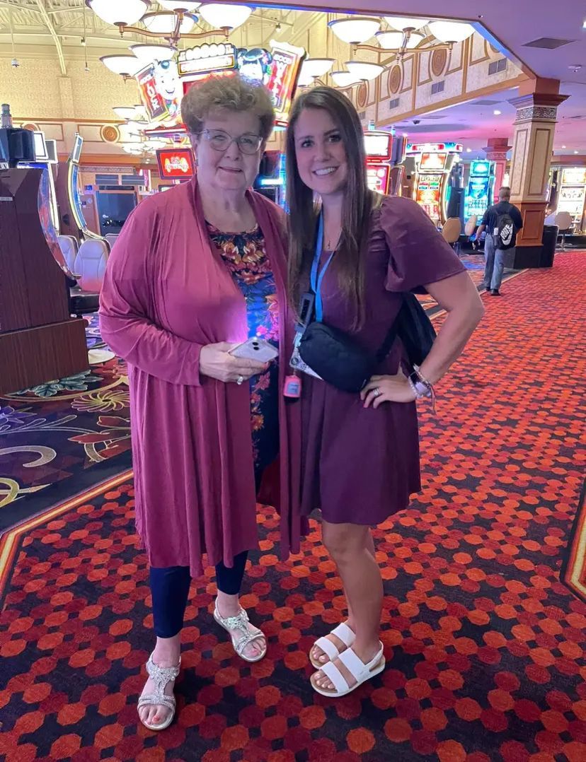Two women are standing next to each other in a casino lobby.