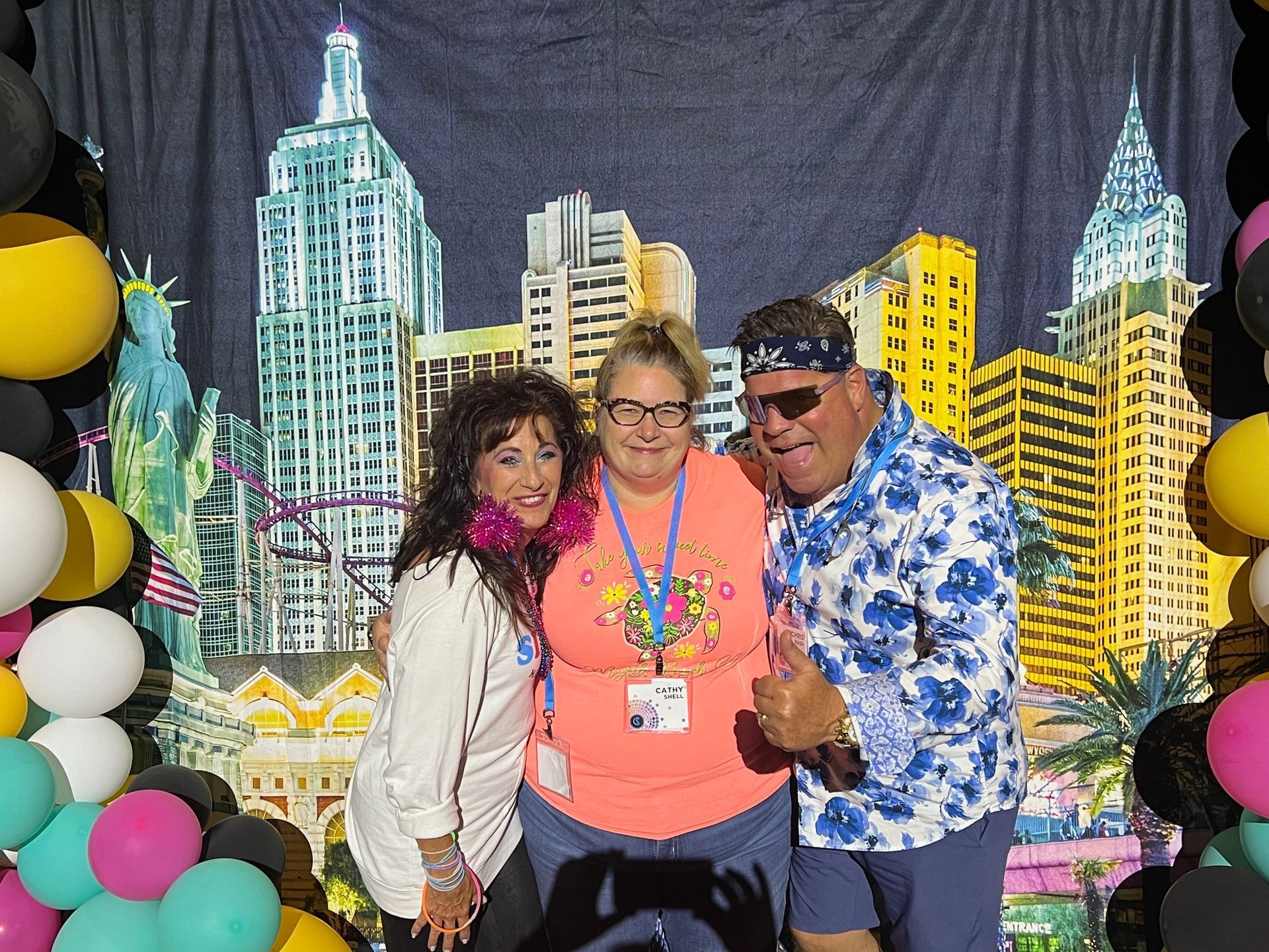A group of people are posing for a picture in front of a city skyline.