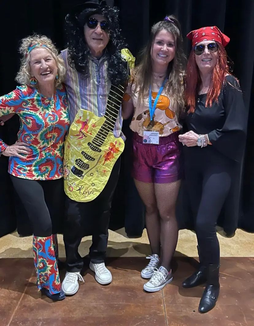 A group of people dressed in costumes are posing for a picture.