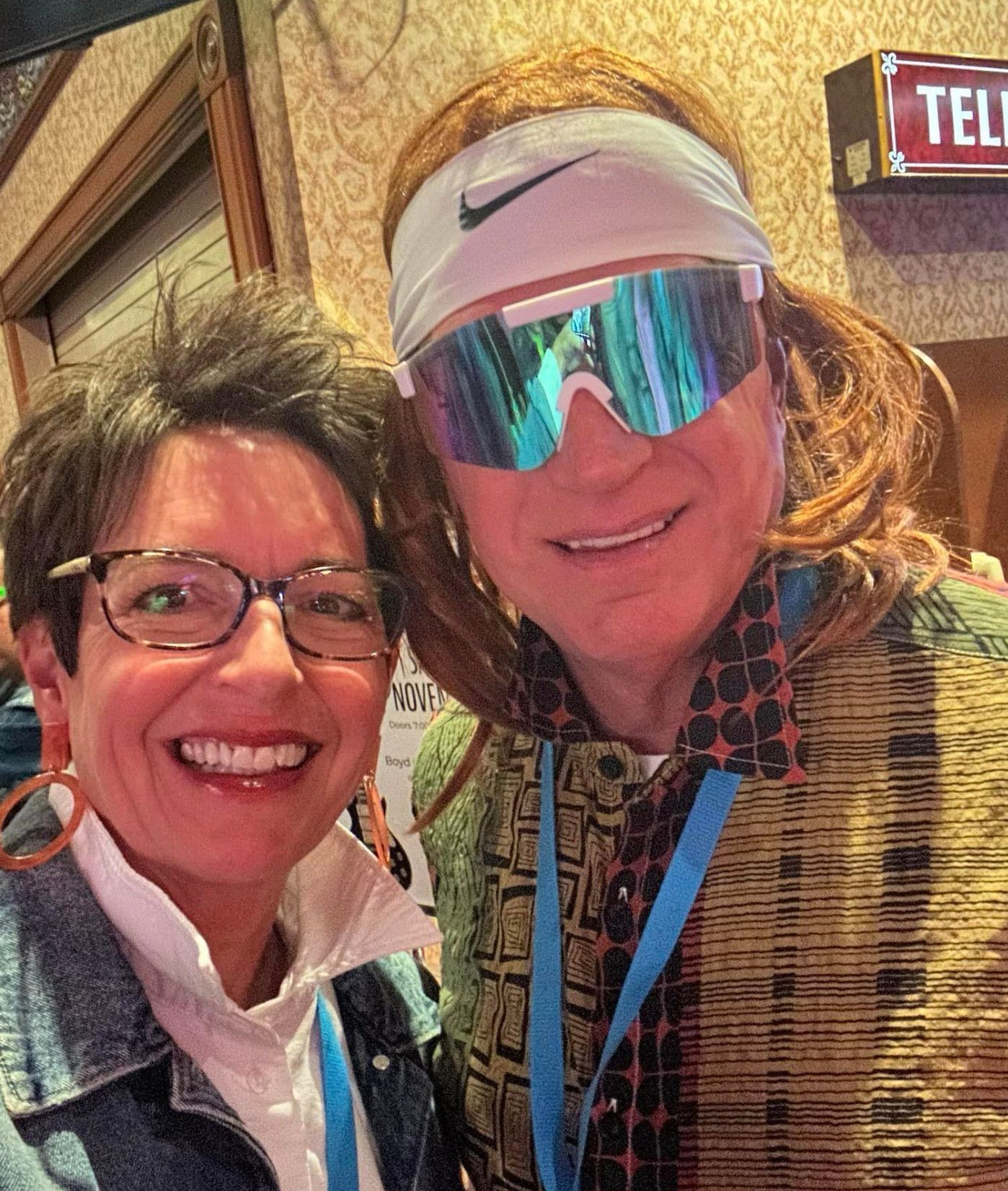 Two women wearing sunglasses and a headband are posing for a picture
