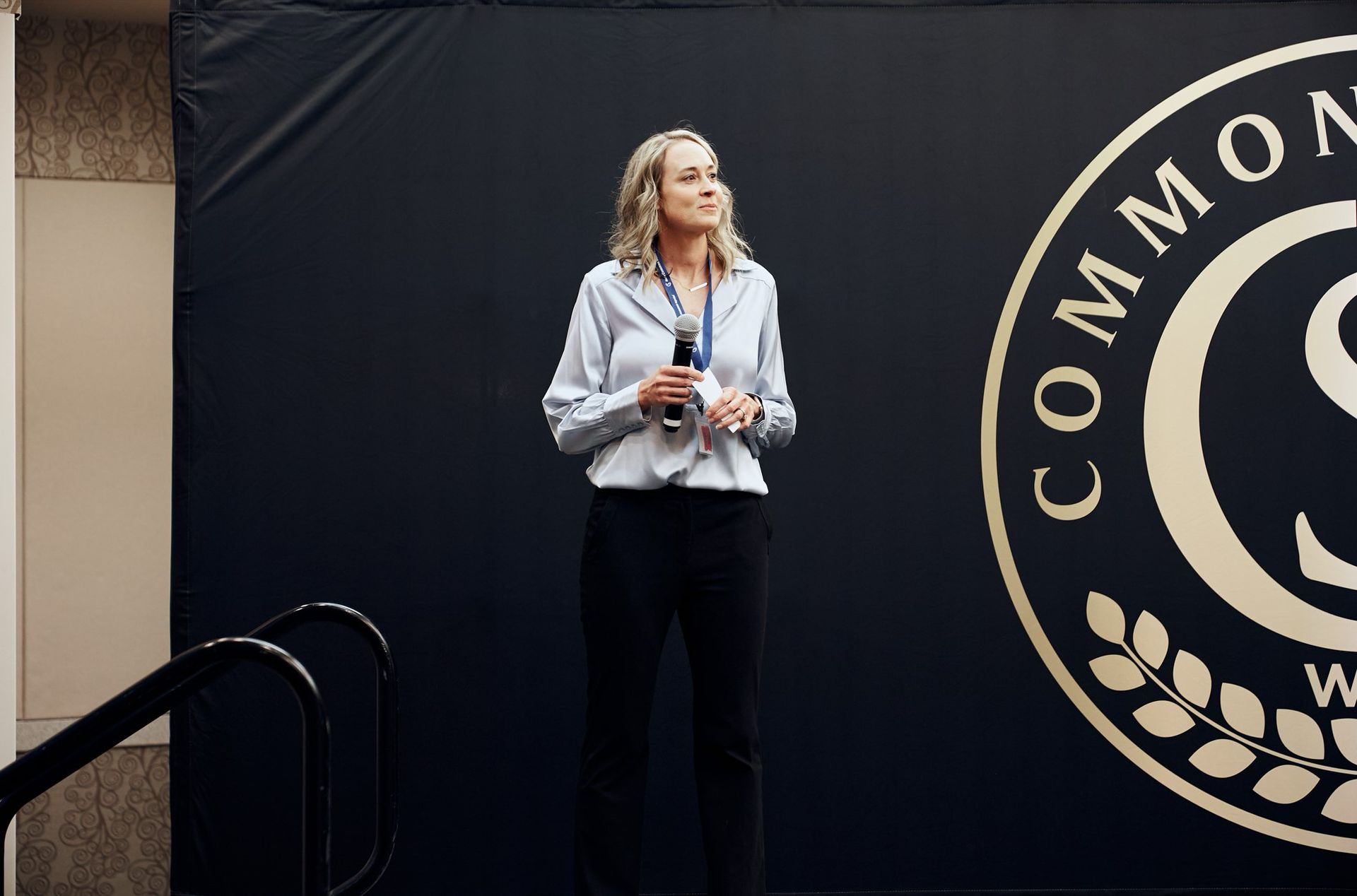 A woman is standing in front of a sign that says commons