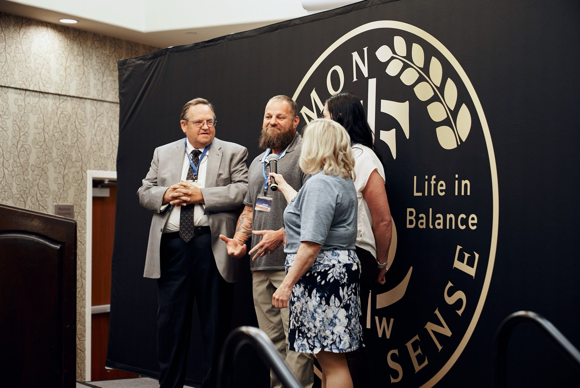 A group of people standing in front of a sign that says life in balance