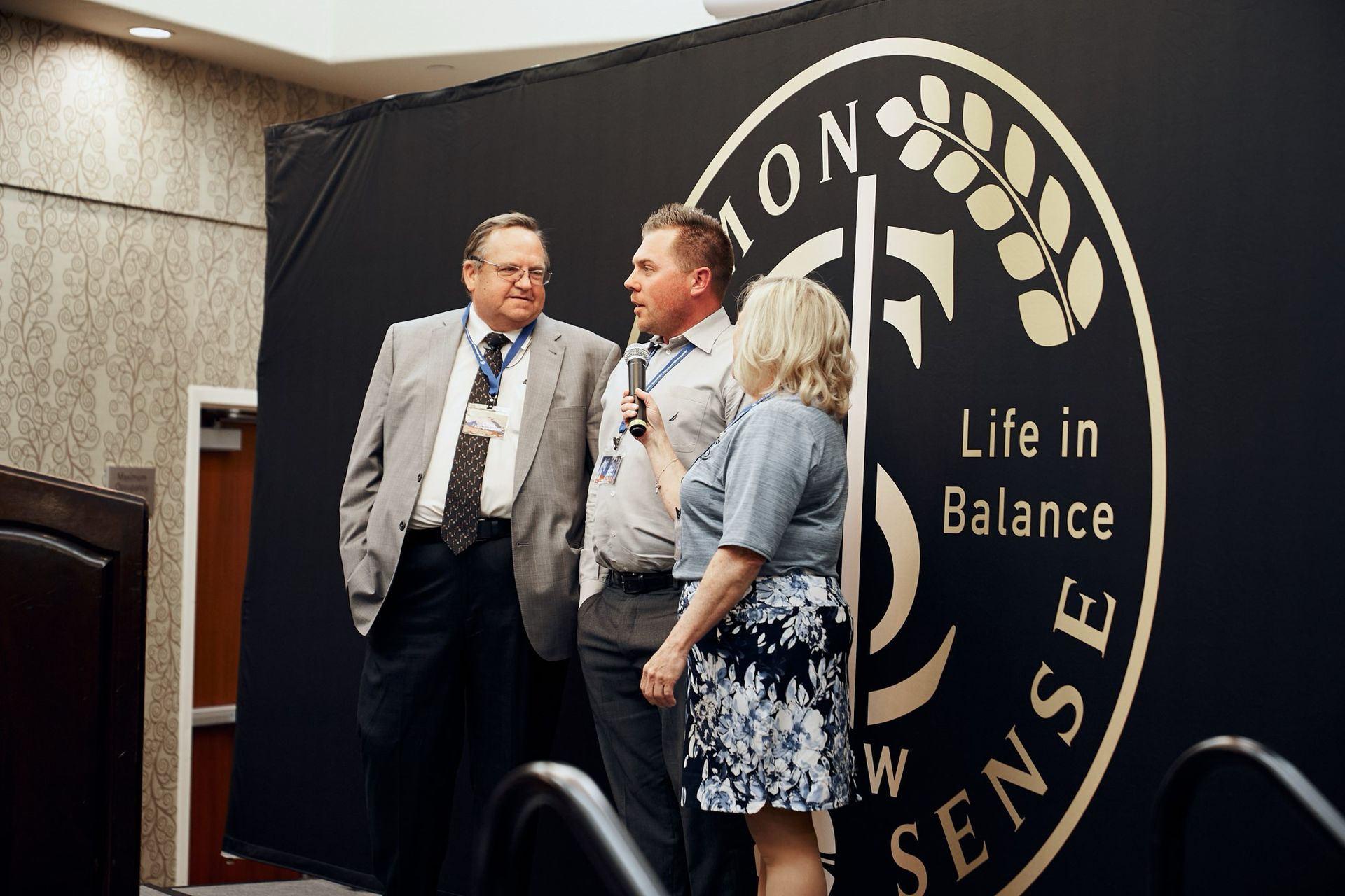 A group of people standing in front of a sign that says life in balance