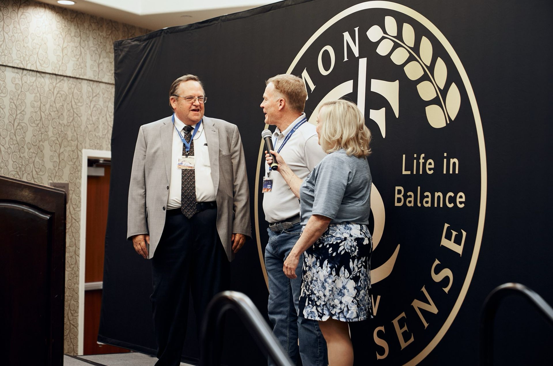 A group of people standing in front of a sign that says life in balance