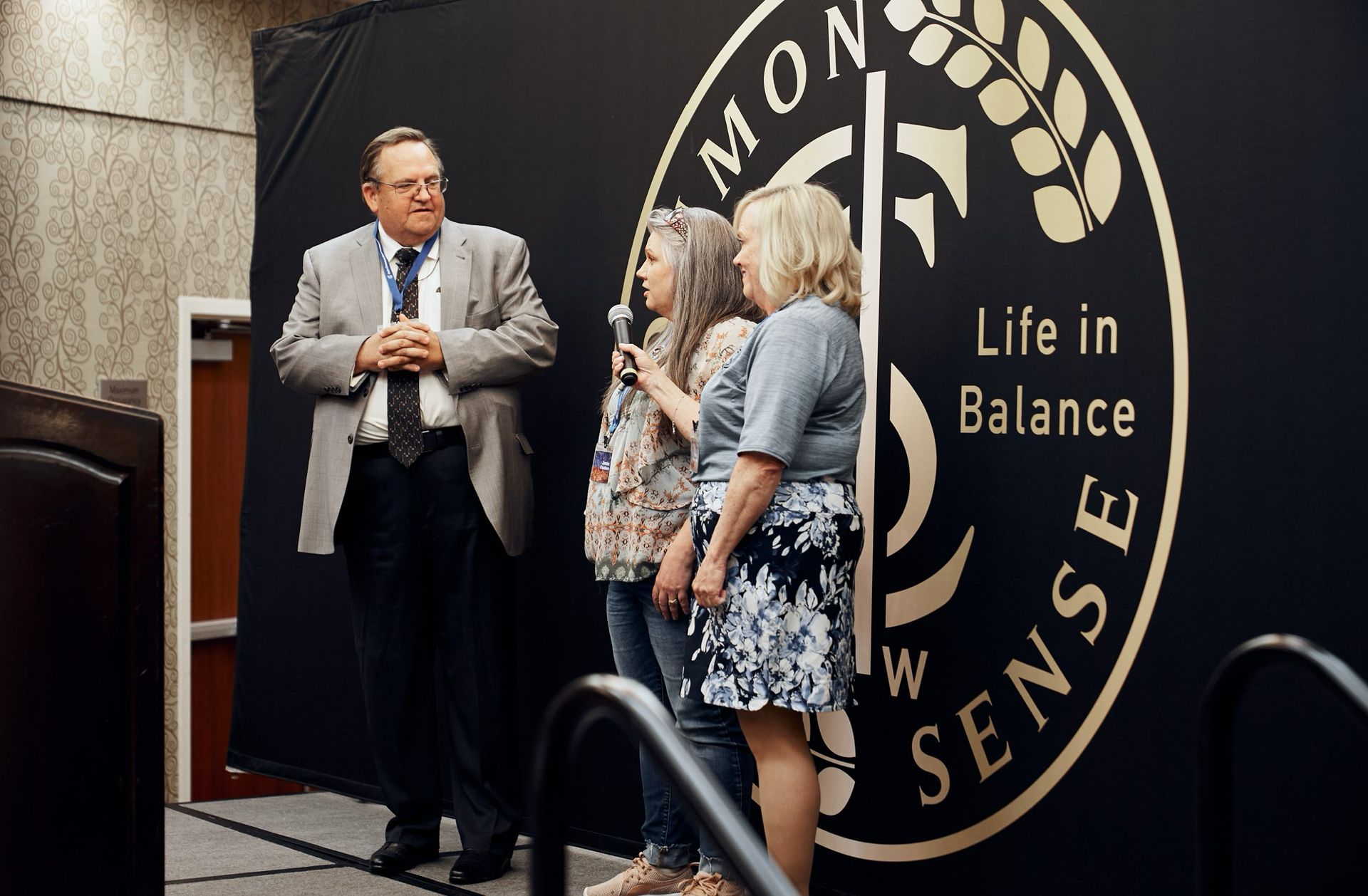 A group of people standing in front of a sign that says life in balance