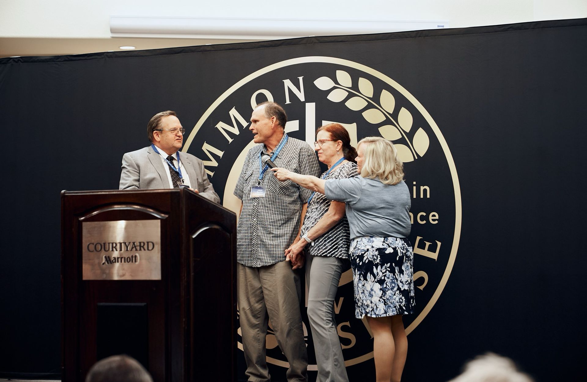 A group of people are standing in front of a podium.