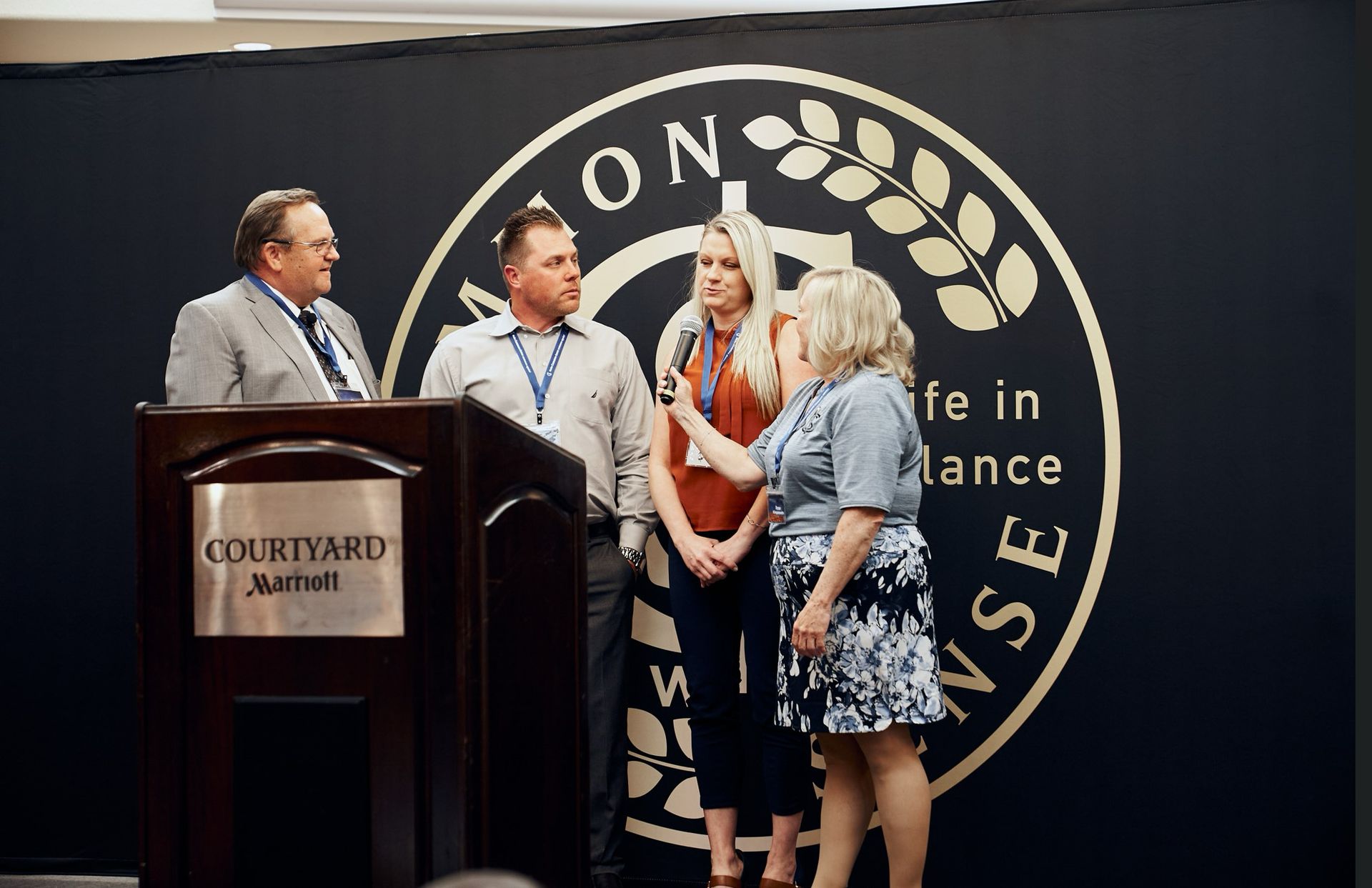 A group of people standing in front of a podium.