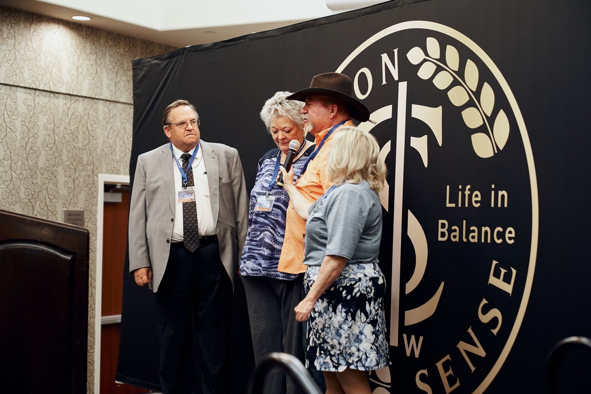 A group of people standing in front of a sign that says life in balance