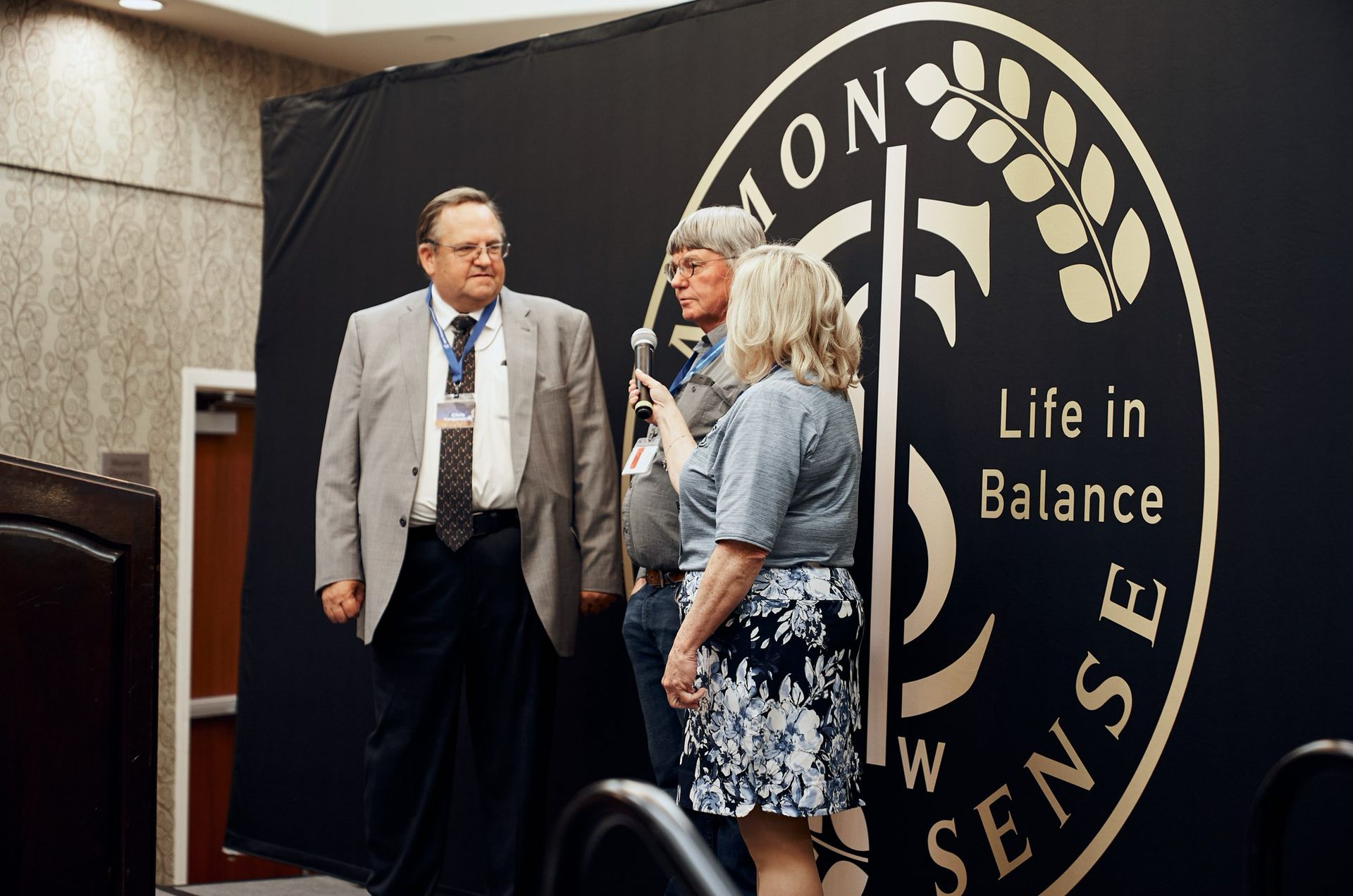 A group of people standing in front of a sign that says life in balance