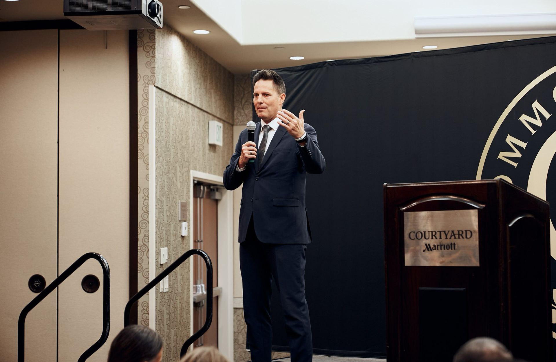 A man in a suit and tie is standing at a podium giving a speech.