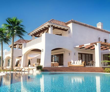 A white truck is parked in a parking lot next to a building.