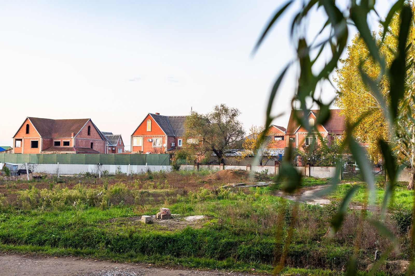 A white truck is parked in a parking lot next to a building.