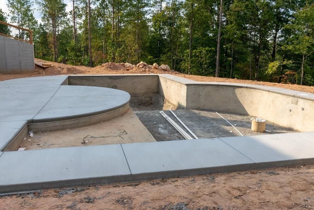 a concrete pool is being built in the middle of a forest