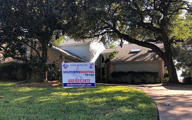 A house with a sign in front of it that says southern roofing