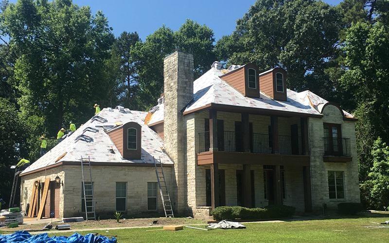 A large house with a roof that is being installed.