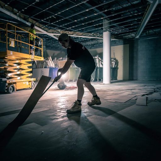 Builder Removing Damaged Floor Tiles — Demolition Services In Gold Coast, QLD