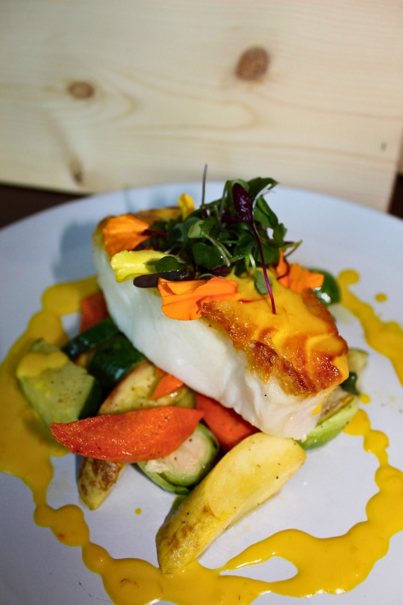 Seared Chilean Seabass
Golden-seared seabass with seasonal veggies and a rich saffron cream sauce.
