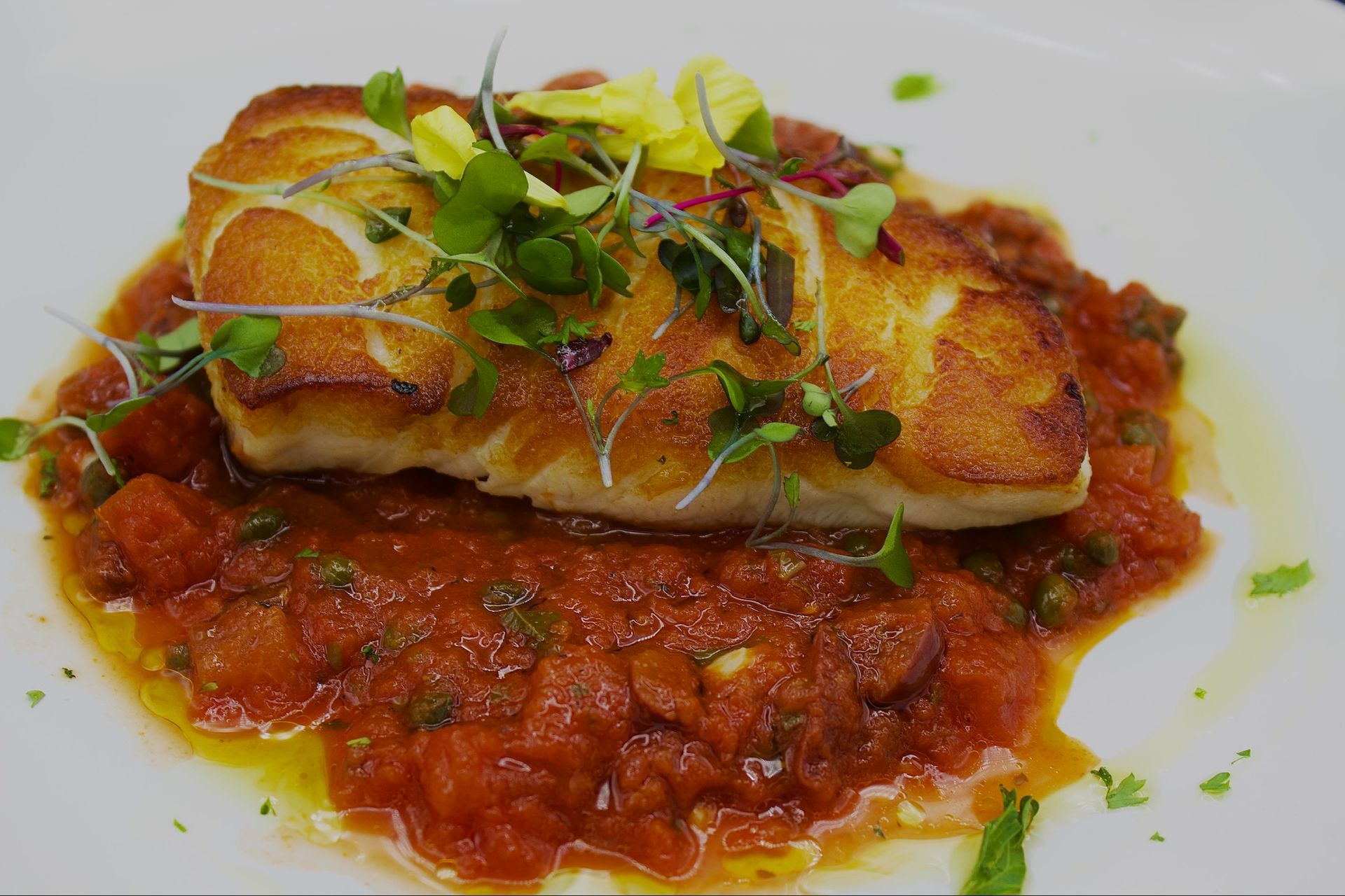 Pan-Seared Chilean Seabass
Laid over a bed of tomato pesto and capers, with fresh seasonal vegetables.
