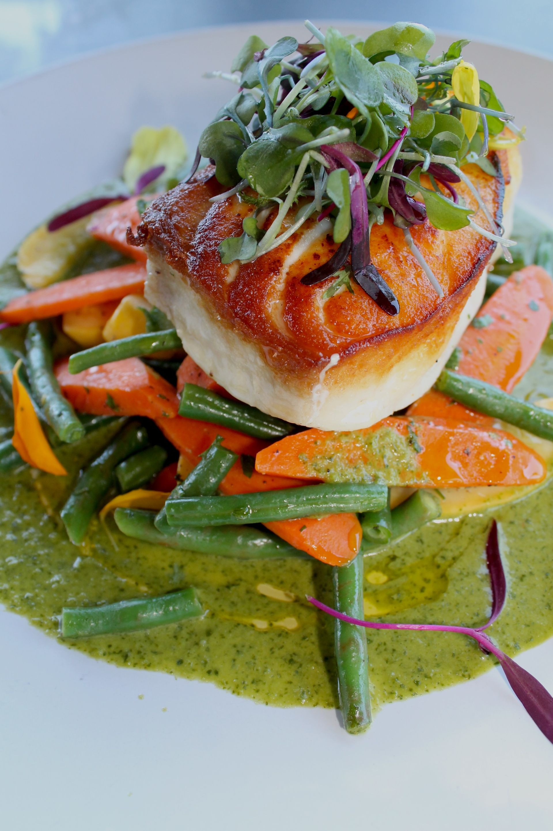 seared Alaskan halibut, drizzled with our zesty cilantro lime sauce  and served with a side of seasonal veggies. 
