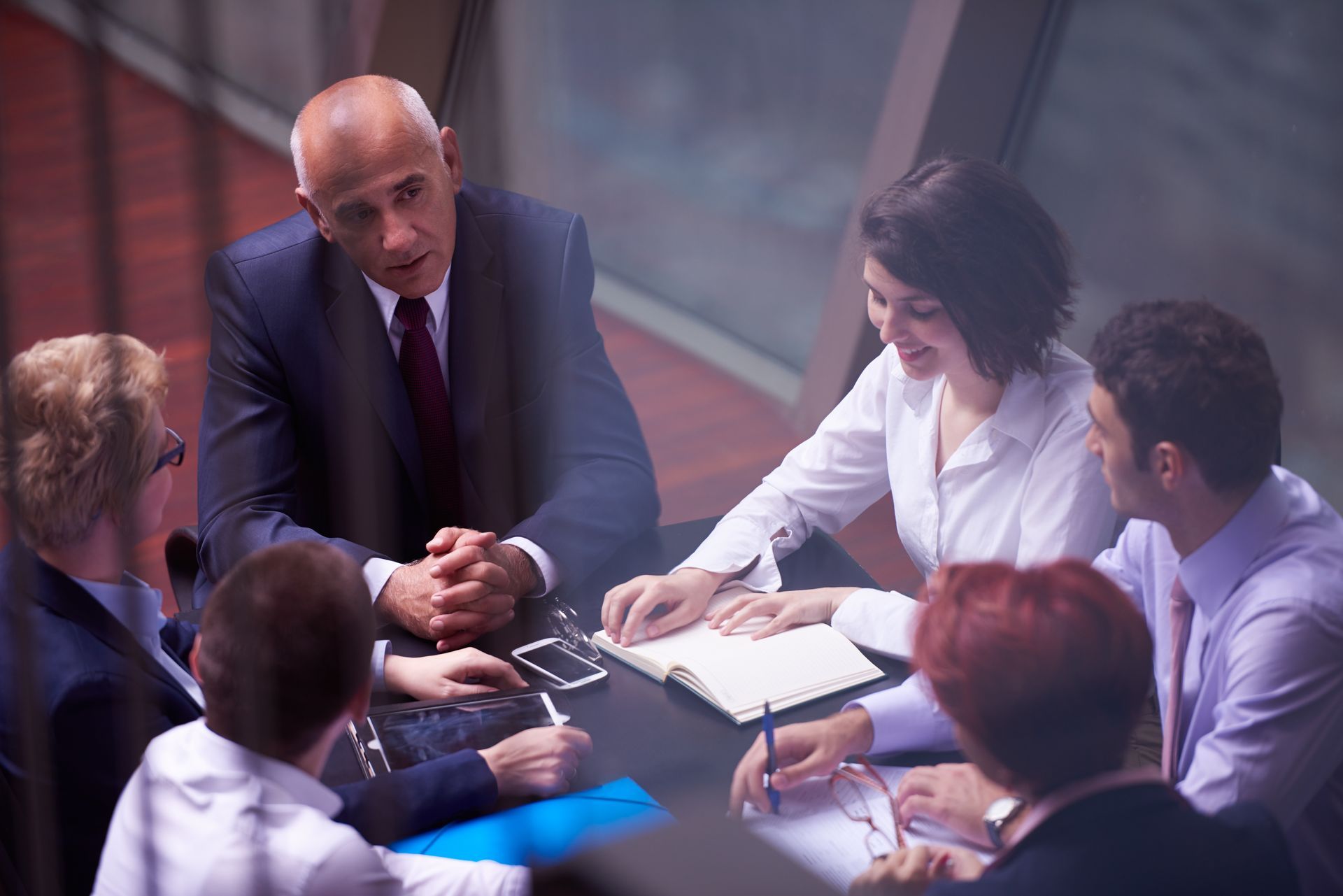 a group of Investors are sitting around a table having a meeting