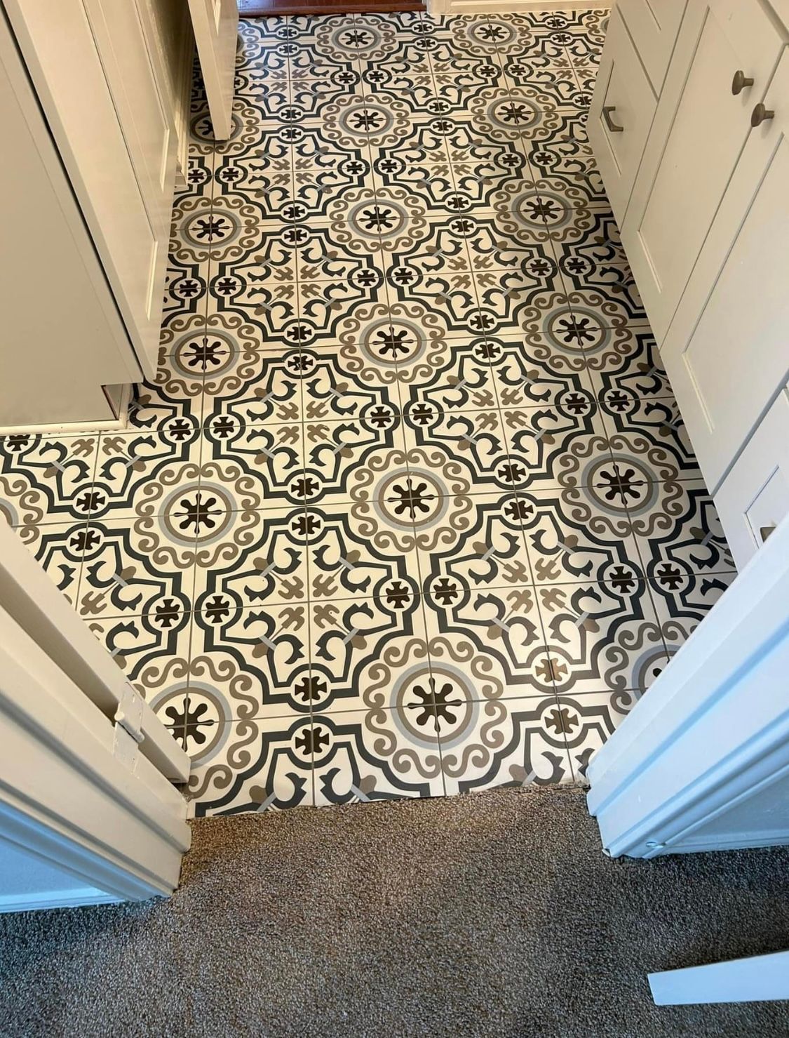 A hallway with a black and white tile floor
