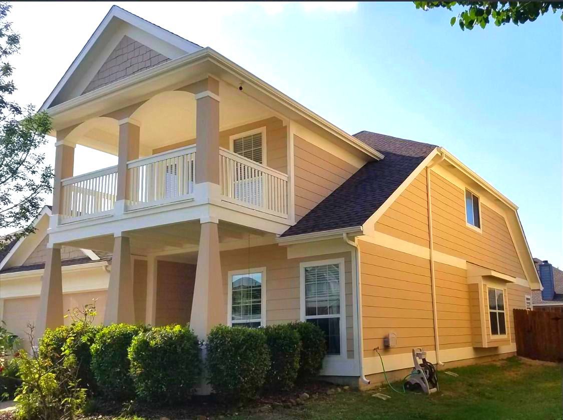 Painter Painting The Trim And Shutters Of Home - Gainesville, TX - Morris Painting & Renovation