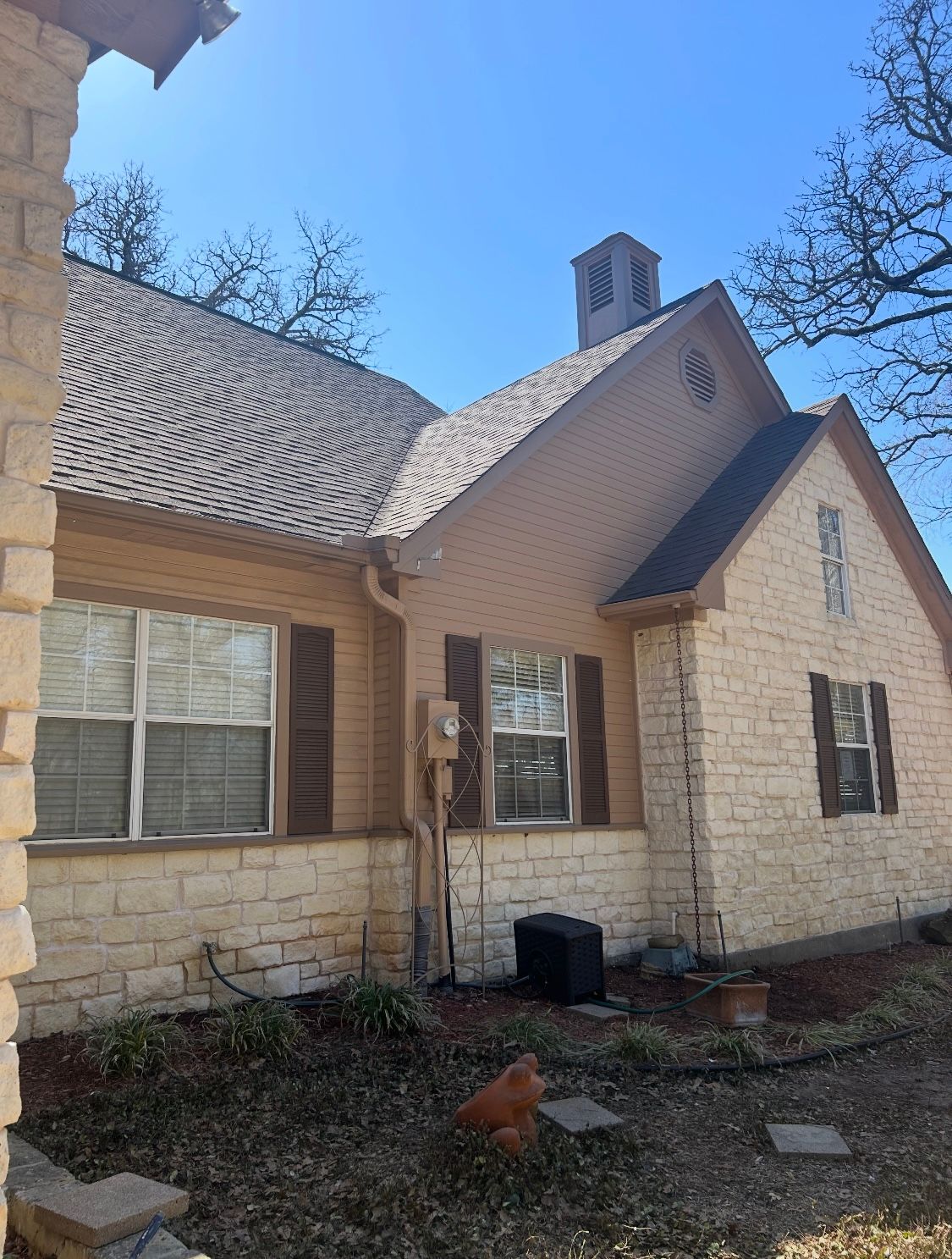 A brick house with a chimney on the roof