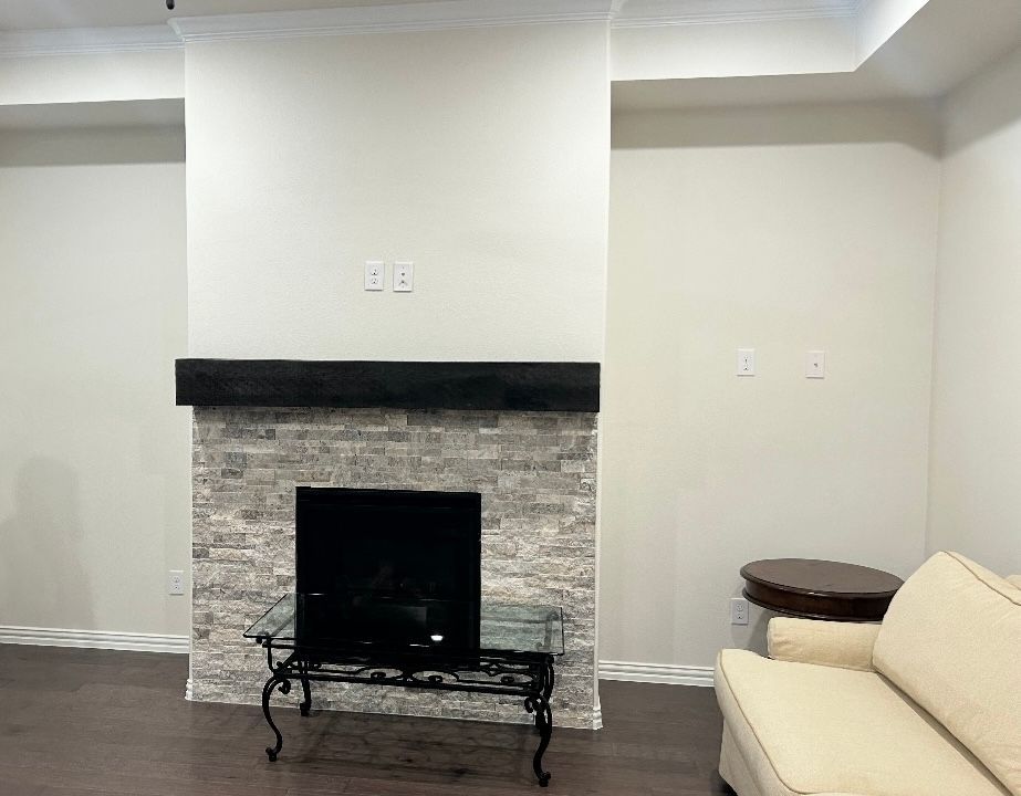 A living room with a fireplace and a couch.