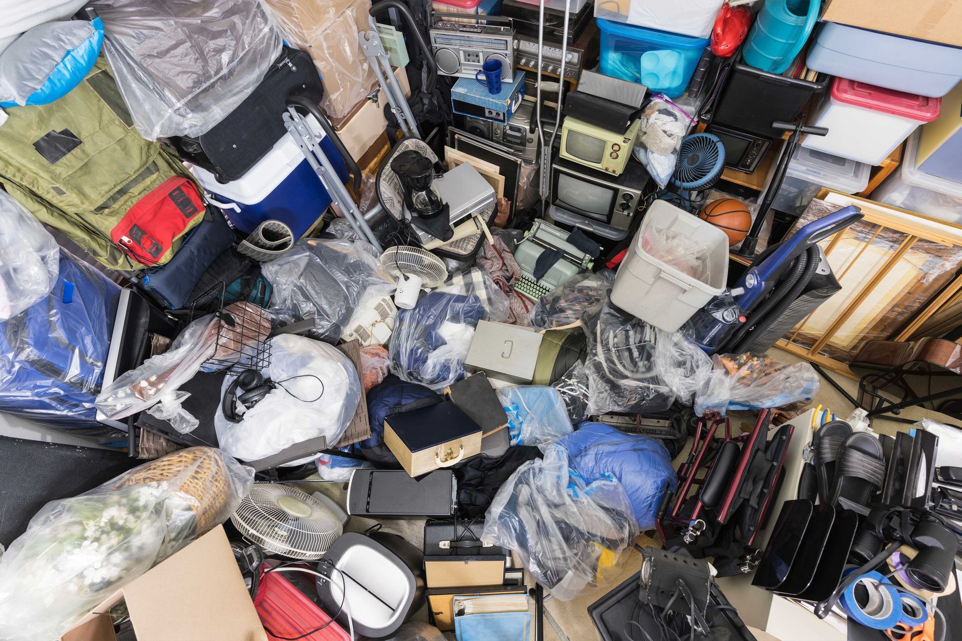 A pile of junk is sitting on the floor in a room.