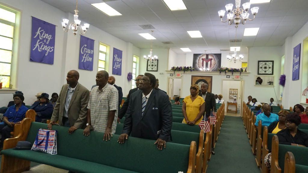 A group of men are standing in a church.