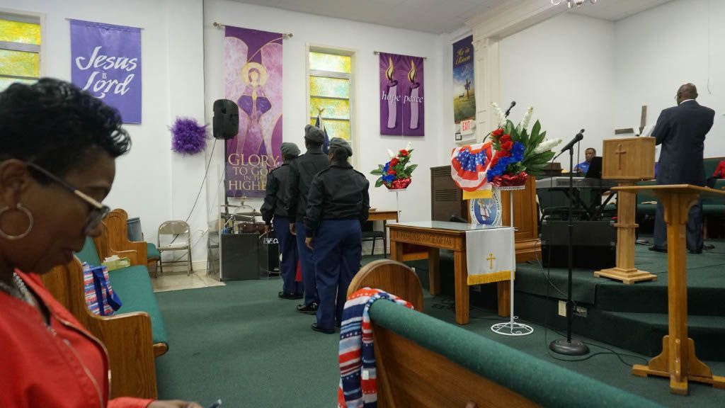 A group of people are standing in a church.