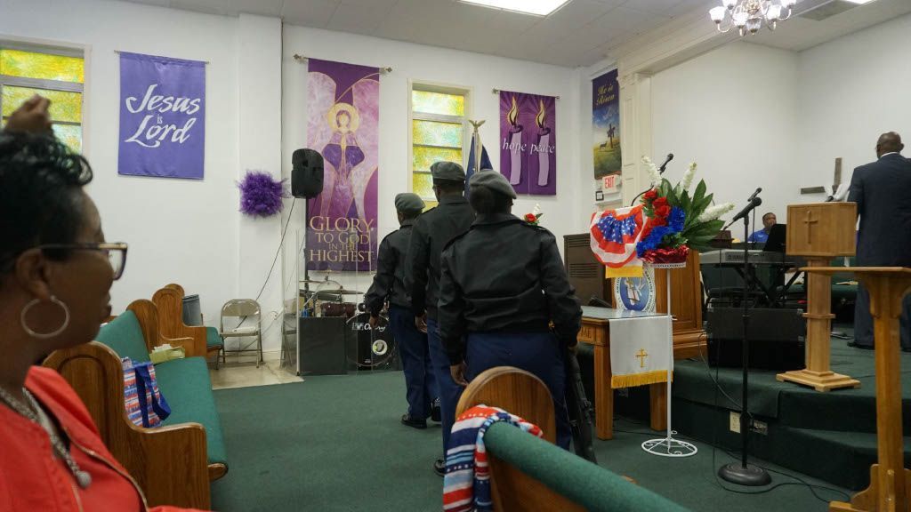 A group of police officers are standing in a church.