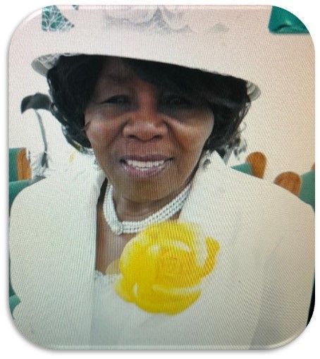 A woman wearing a white hat with a yellow flower on her neck
