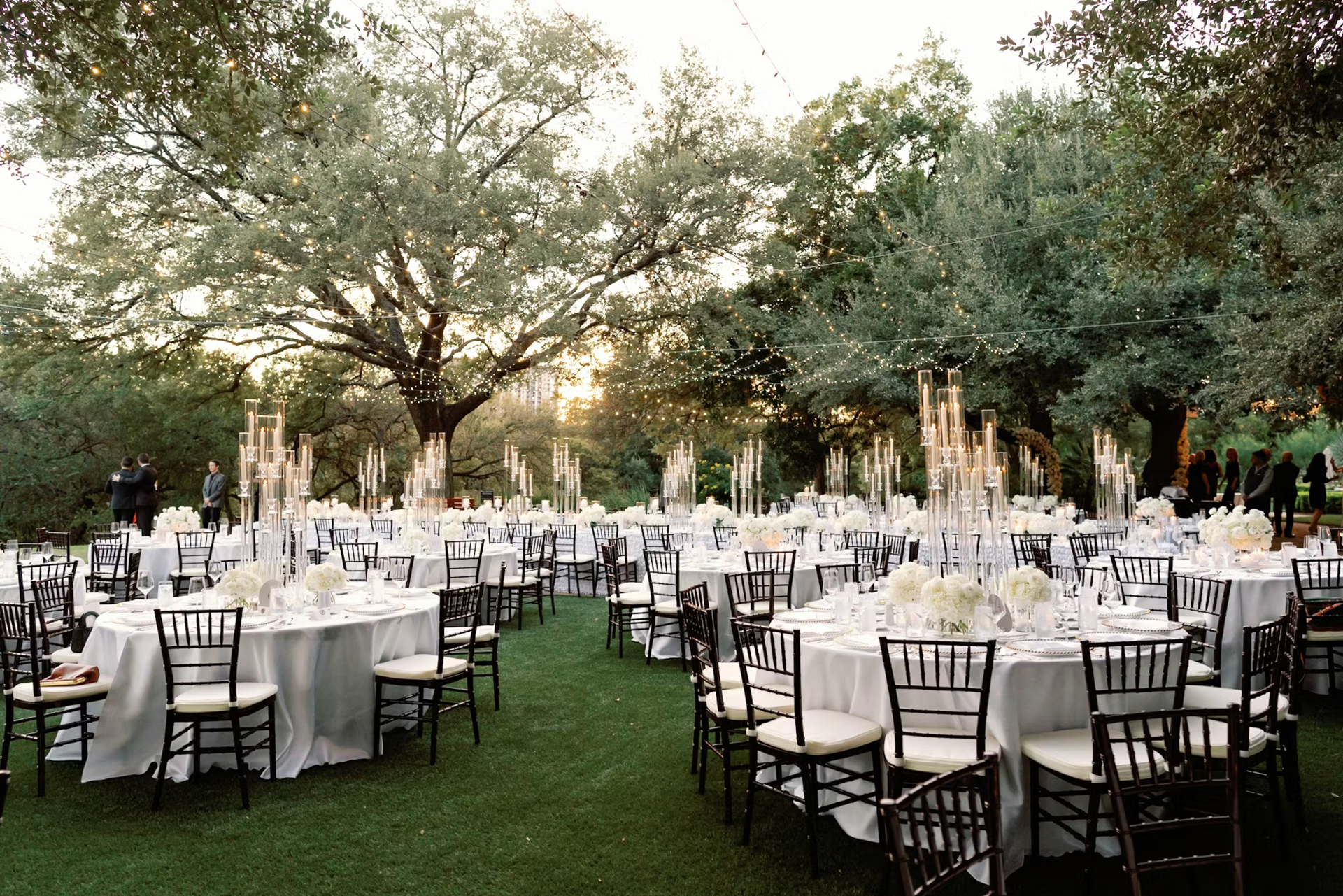 A large lawn filled with tables and chairs set up for a wedding reception at the Four Season Hotel in Downtown Austin Texas